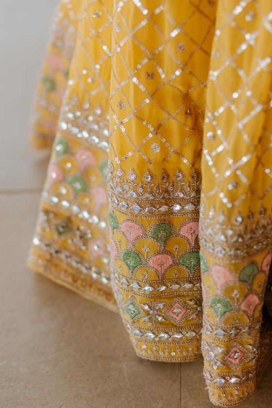 Gold embroidery detail of the bride's haldi lehenga