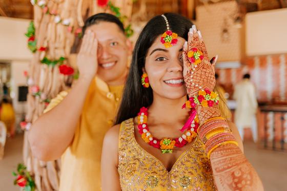 Turmeric paste pressed onto the couple's faces