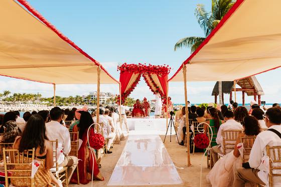View down the aisle to the mandap, guests seated