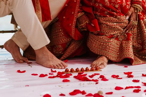 Feet stepping through the seven steps amid rose petals