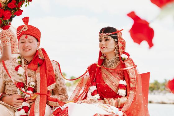 Rose petals thrown over the couple at the mandap