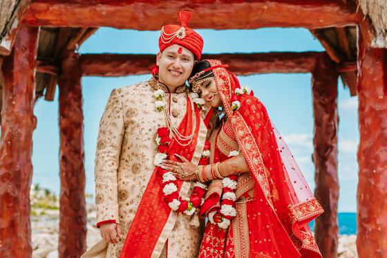 Couple embracing under the palapa, sea behind