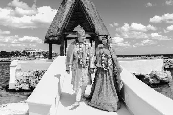Black and white of the couple crossing the bridge