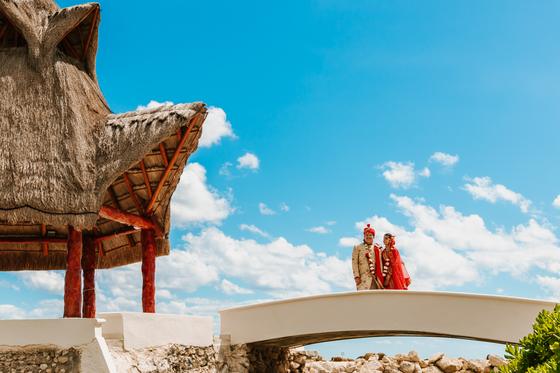 Couple crossing the bridge, wide, sky above