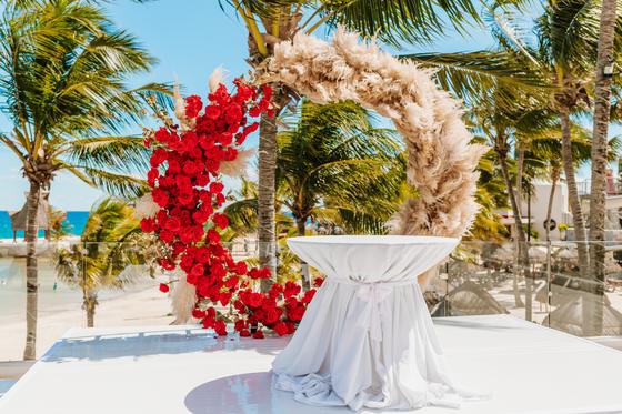 Dressed altar table framed by the floral arch