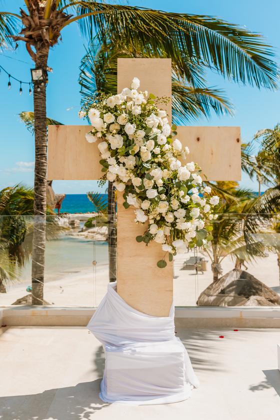 Floral arch and pedestal against the palms