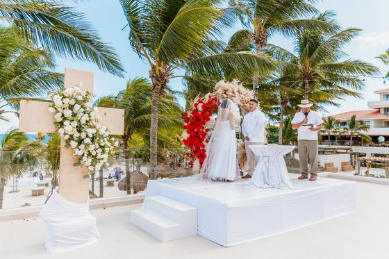 The Catholic ceremony setting, cross and arch on the sand