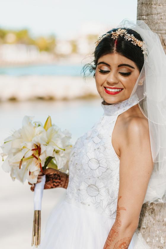 Bride with her bouquet, water behind her