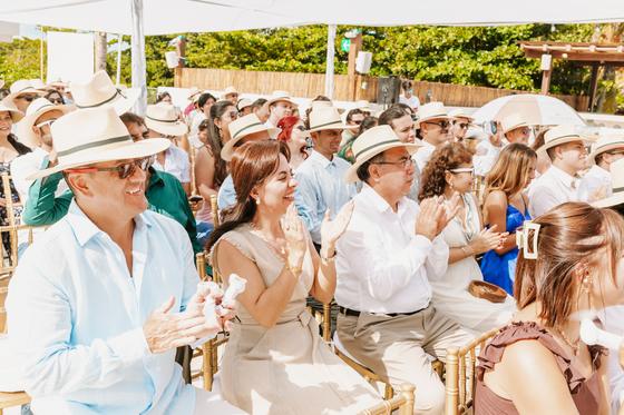 Guests in panama hats watching the ceremony