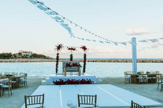 Sweetheart table framed by florals against the water