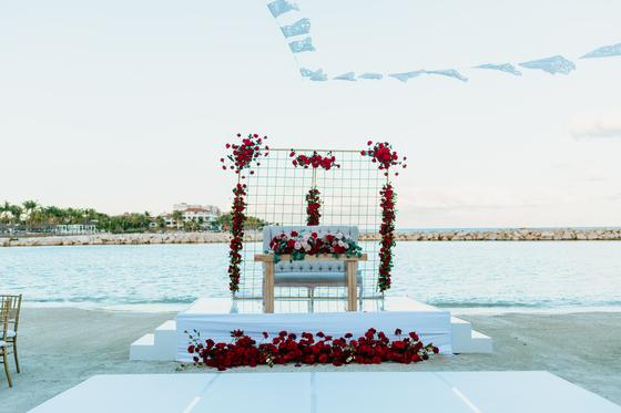 The couple's table dressed with roses at the shoreline