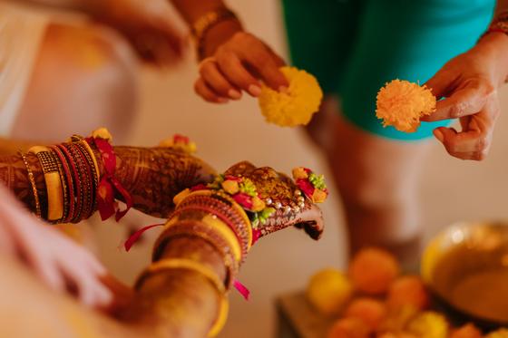 Bangled wrists dusted with turmeric