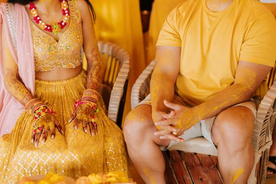 Turmeric-covered hands resting together