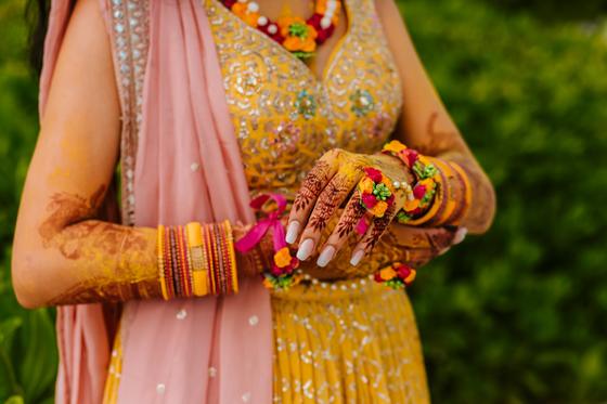 Bridal henna and floral kaleere across both hands