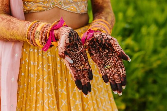 Both palms turned up, mehndi finished to the wrist