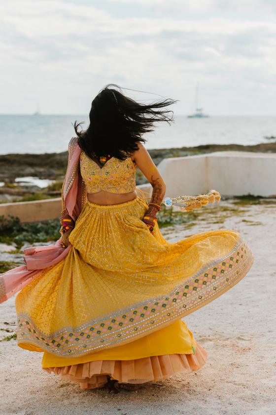 Bride twirling beneath a palm, skirt flaring