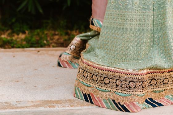 Gold and mint border detail of the bride's lehenga