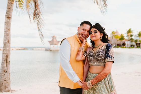 Couple embracing on the sand with the lagoon behind