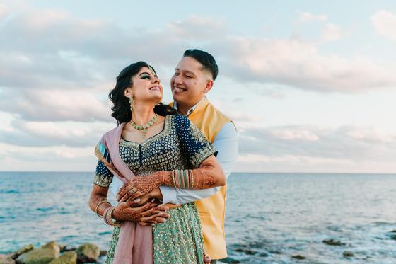 Couple embracing with the open ocean behind them