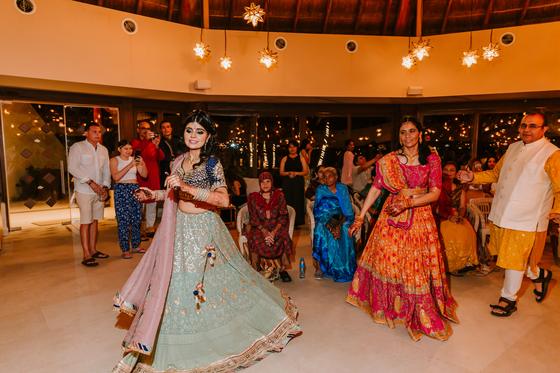 Dancing under string lights at the sangeet