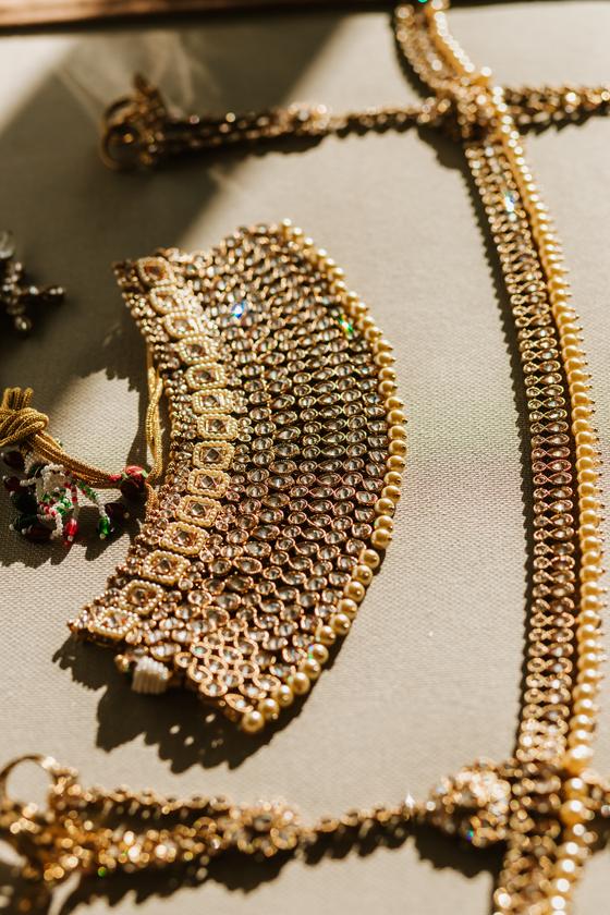 Antique gold bridal jewellery laid out before dressing