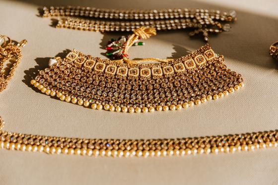 Layered gold temple necklace arranged on cloth