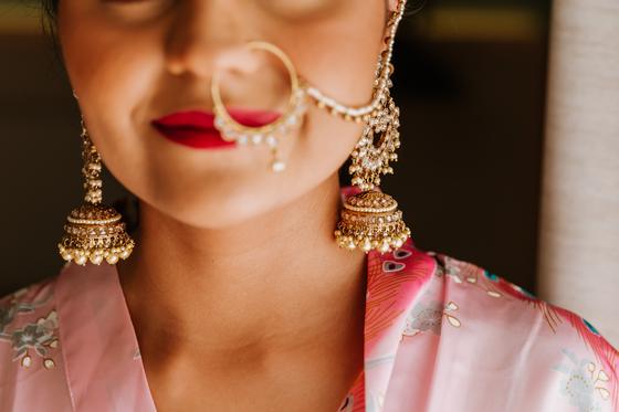 Close detail of the bride's nath and jhumka earring