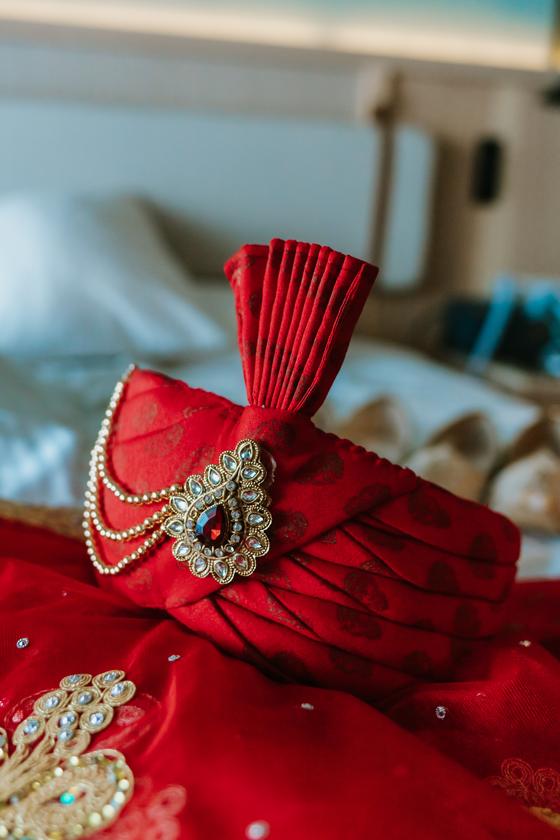 Red safa and brooch laid ready for the groom