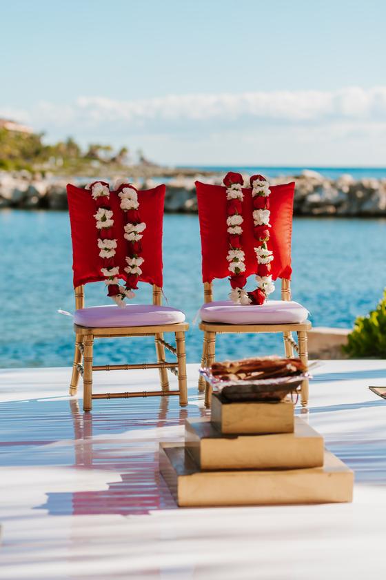 Garlanded chairs set out beside the water