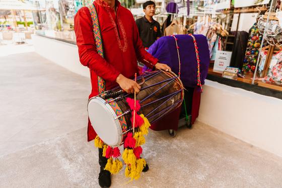Hands striking the dhol during the baraat