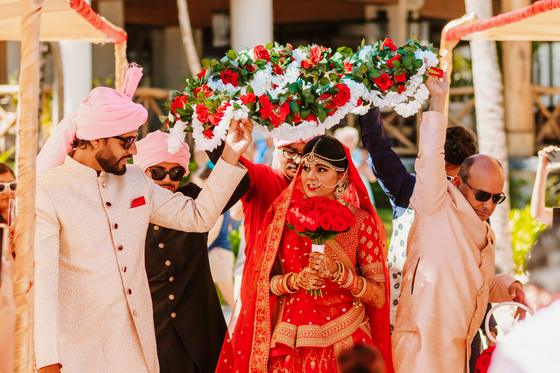 Bride entering beneath a canopy of flowers
