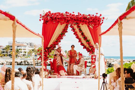 The mandap from the aisle with guests seated